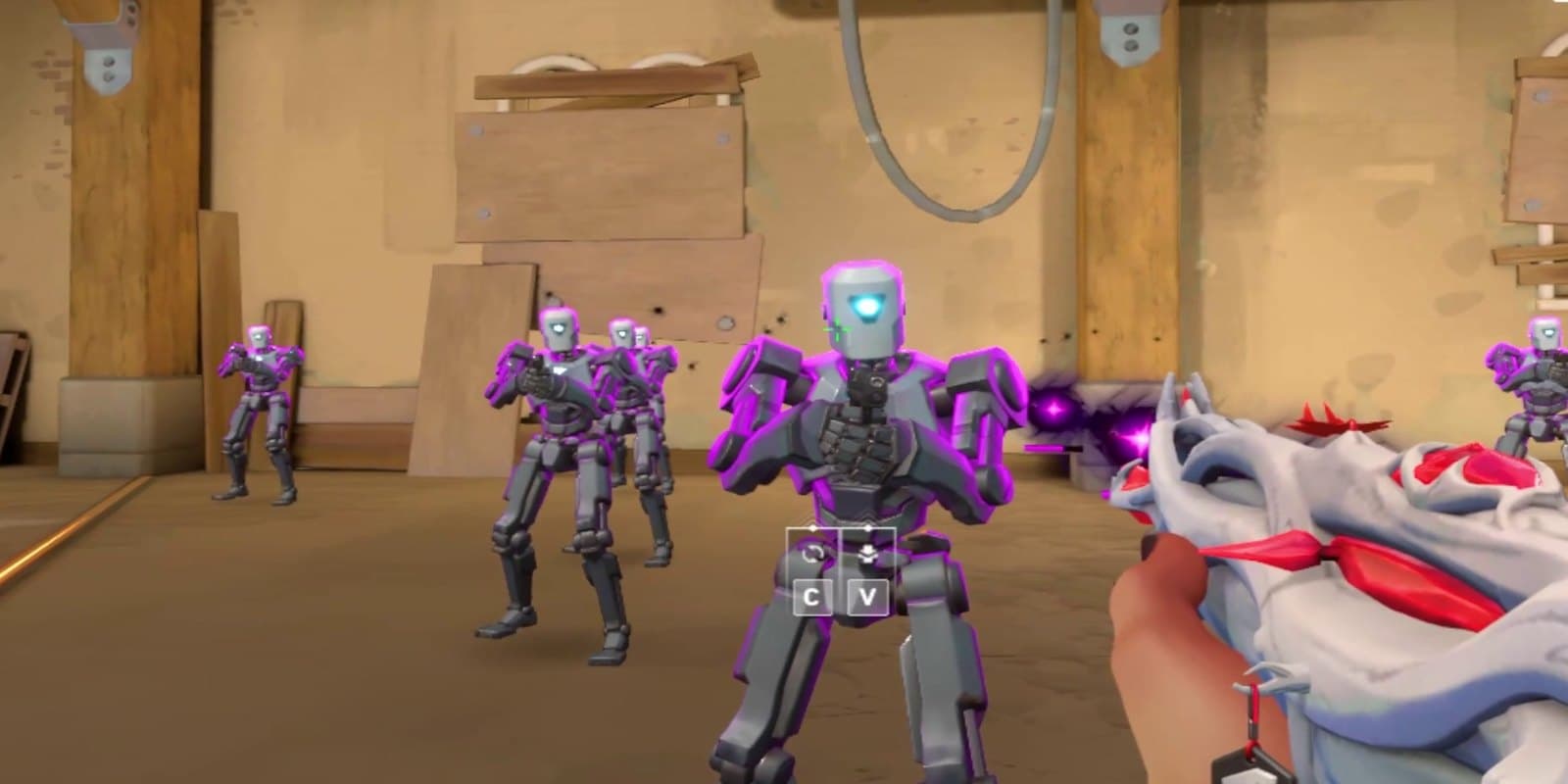 VALORANT gameplay: practice bots on the Range, seen past the player's weapon.